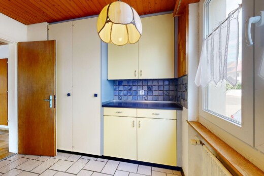 kitchen featuring backsplash, wood ceiling, dark countertops, white cabinets, and radiator heating unit