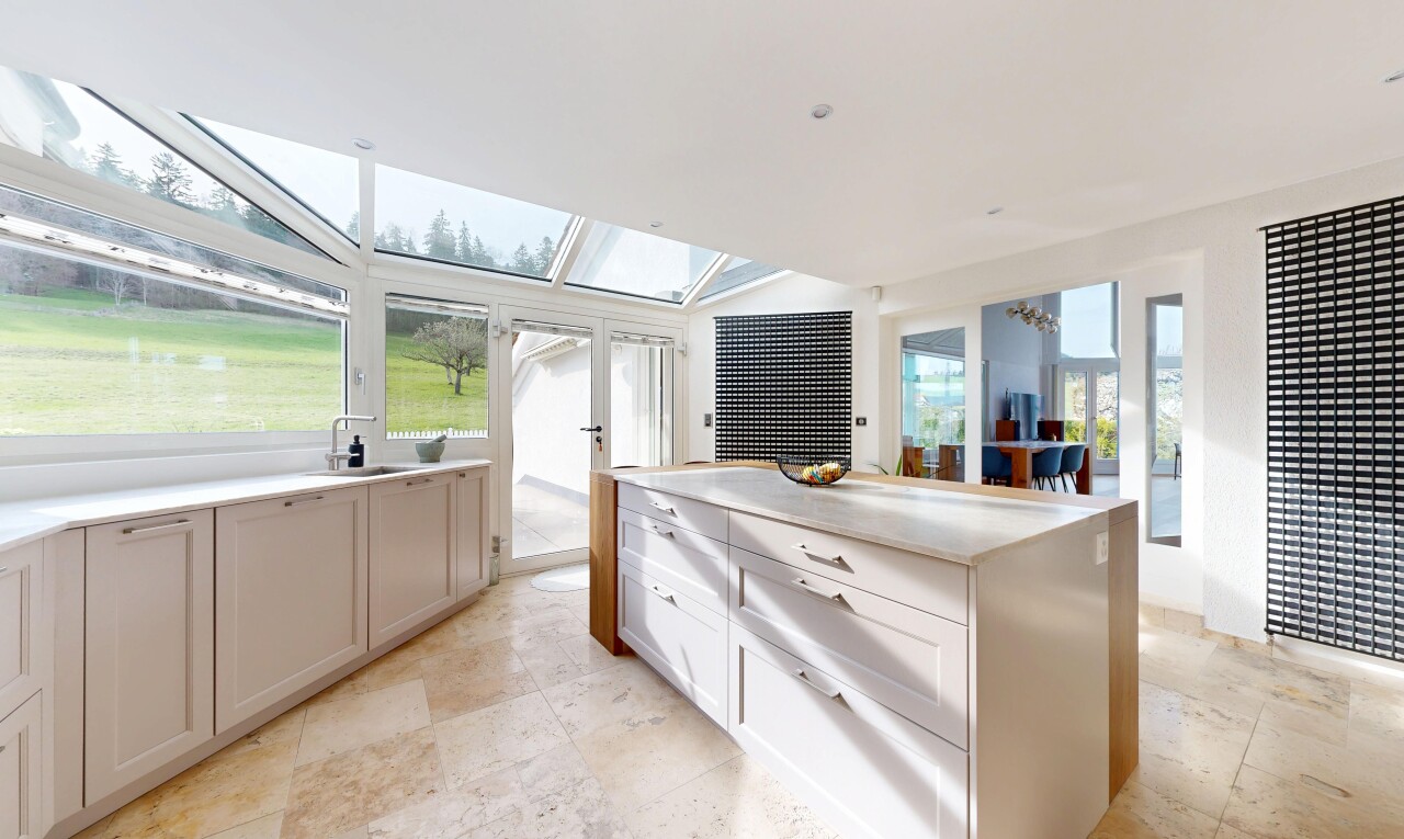 cuisine avec armoires de style shaker, shaker cabinets, light floor, light countertops, et îlot de cuisine