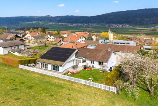 outdoor house featuring solar panels, a mountain view, and a residential view