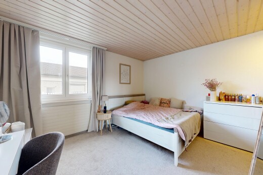 room with wooden ceiling and light colored carpet