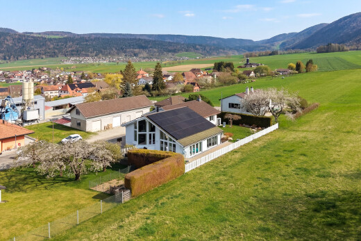 view of property featuring a mountain view and a sunroom
