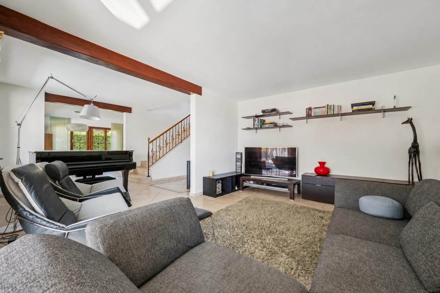 salon avec escaliers, cloison sèche, drywall, télévision, et high end ceiling