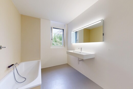 bathroom featuring a garden tub and a sink