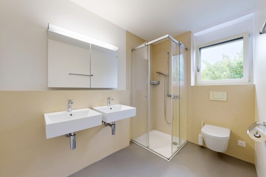 bathroom featuring a shower stall and finished concrete flooring