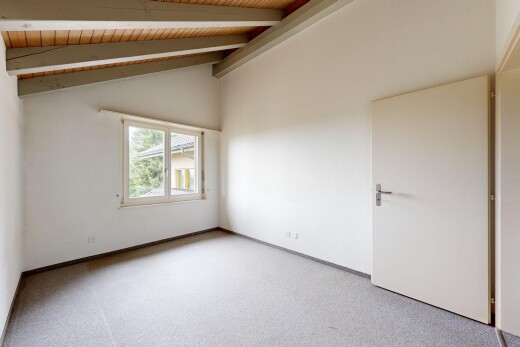 spare room featuring carpet floors and wood ceiling