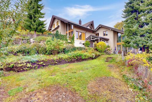 outdoor house with stucco siding and a chimney