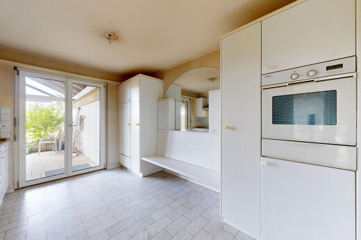 kitchen with white oven and white cabinetry
