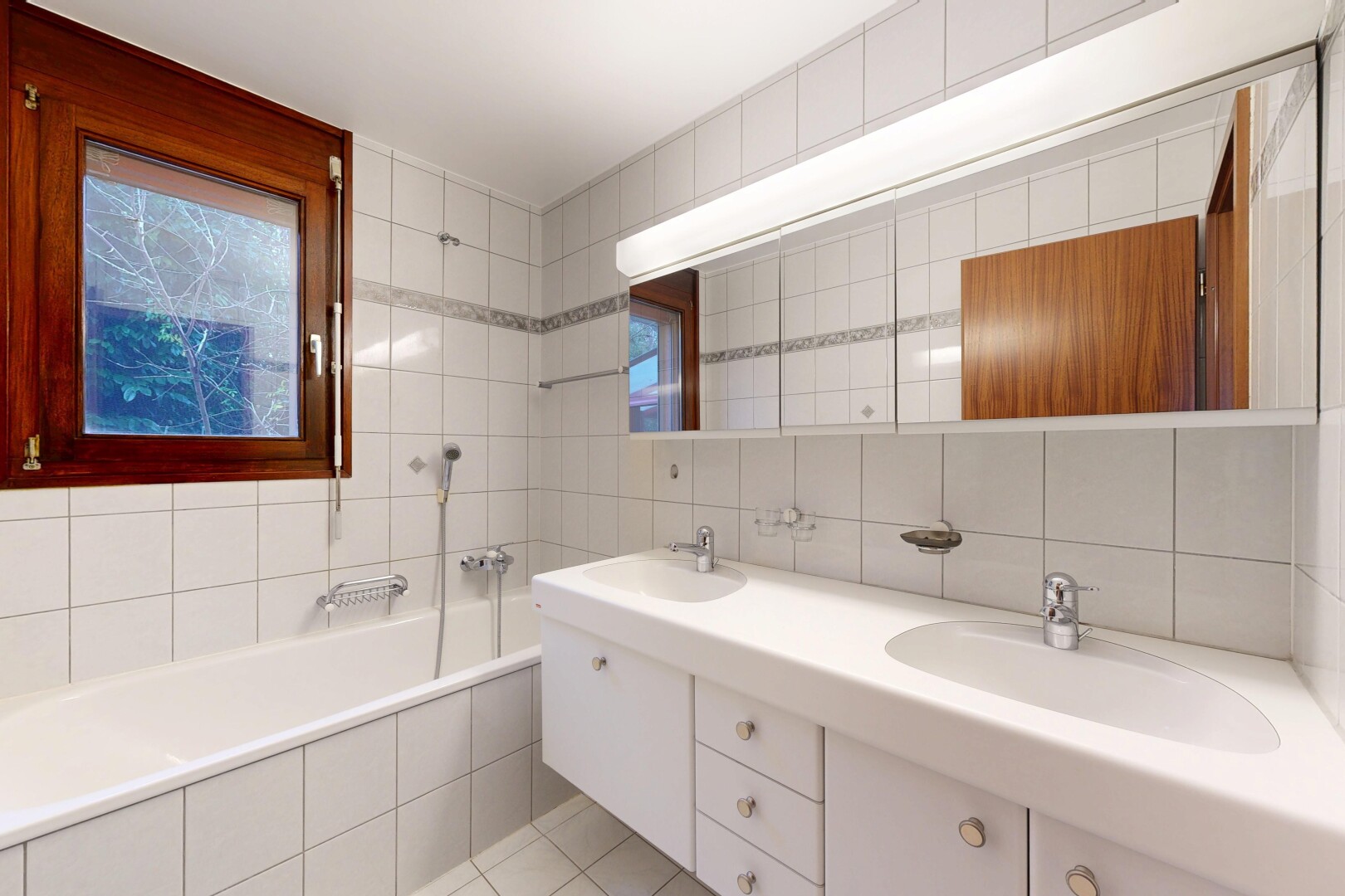 salle de bains avec salle de bain complète, double vasque, bain, mur en carrelage, et tile wall