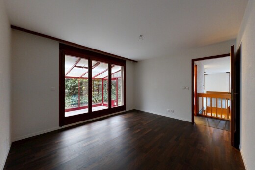unfurnished room featuring dark wood-type flooring and baseboards