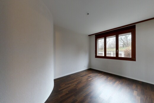empty room with dark wood finished floors and baseboards