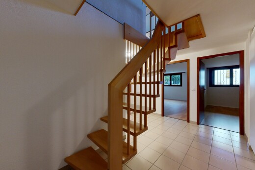 staircase featuring tile patterned floors
