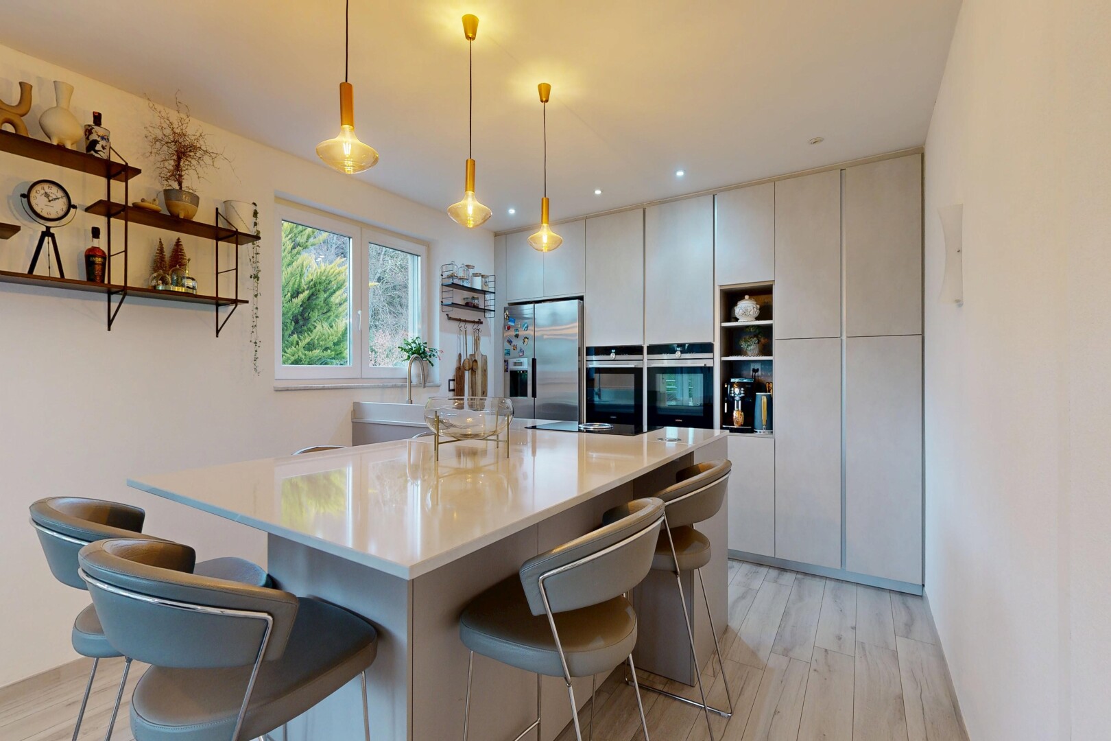 kitchen featuring open shelves, decorative light fixtures, a breakfast bar area, stainless steel appliances, and light wood-style floors