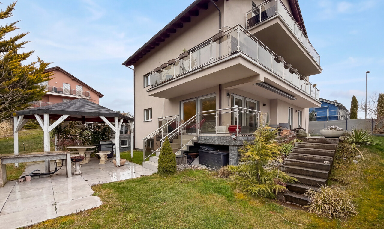 view of home featuring a balcony, a patio, stucco siding, a yard, and a gazebo