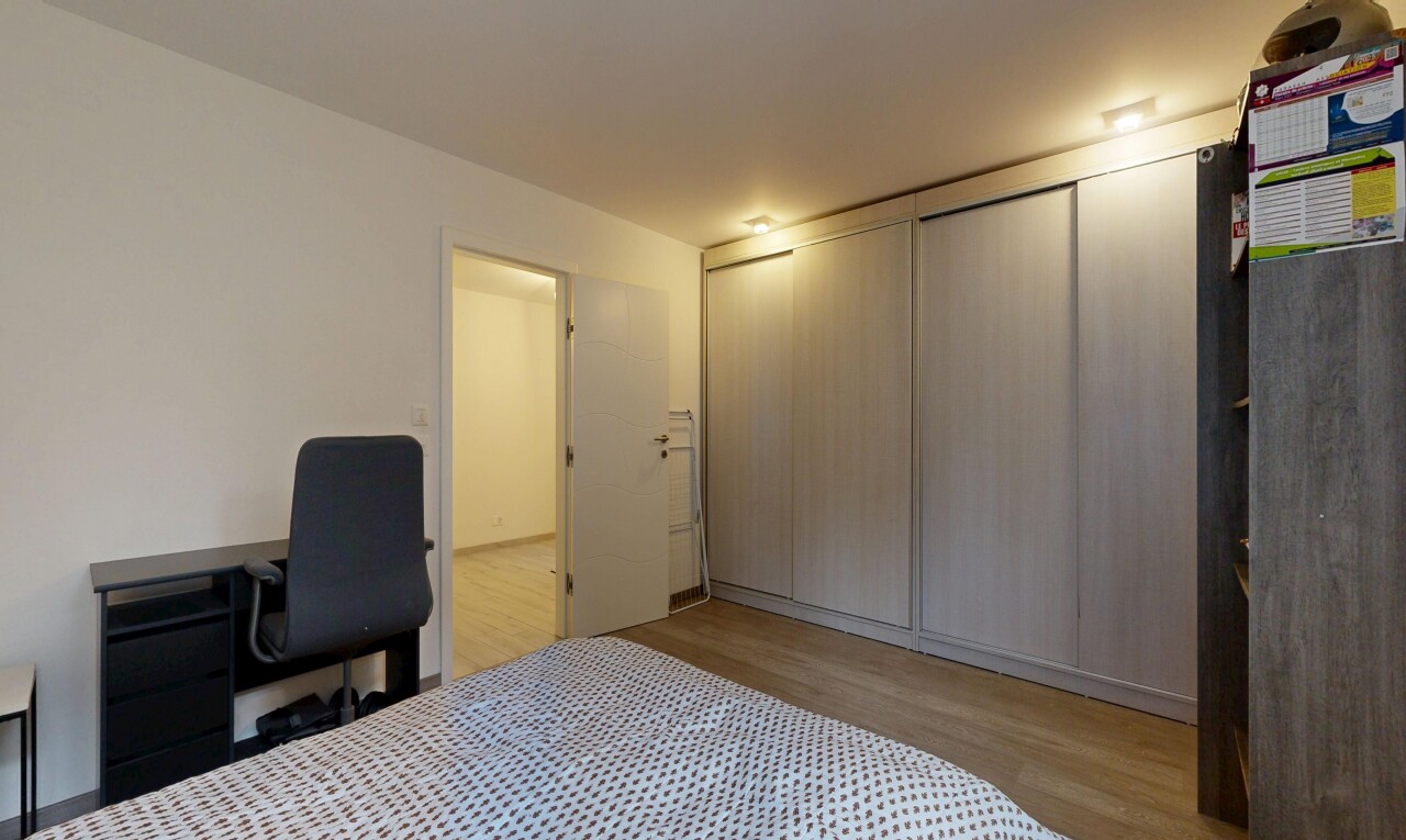 room with light wood-type flooring and a closet
