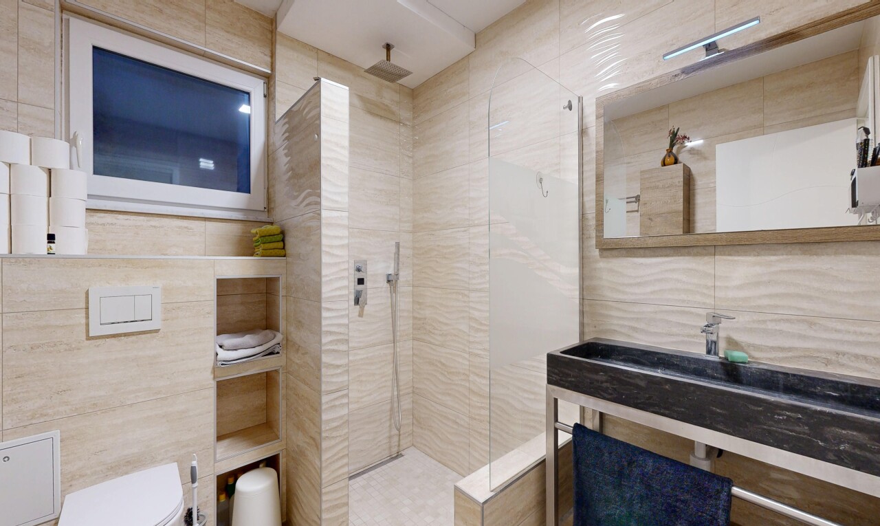full bathroom featuring tile walls and a walk in shower