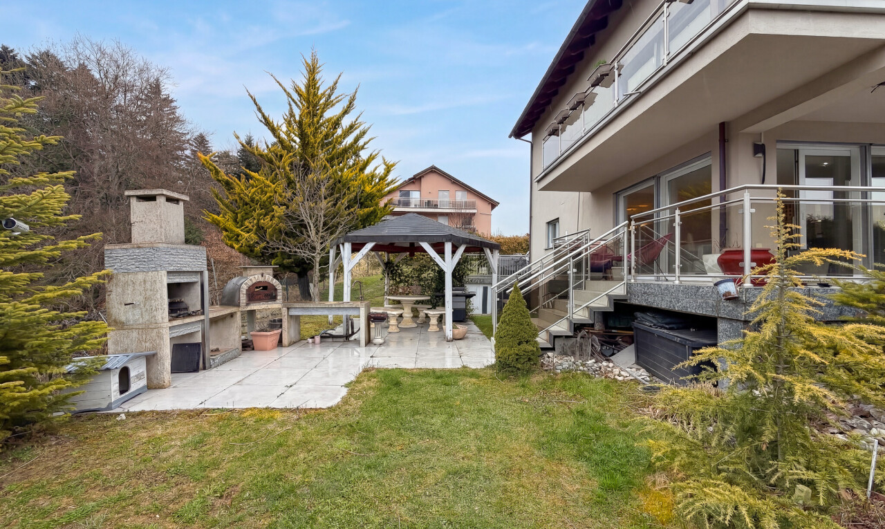 garden featuring a patio area, a gazebo, an outdoor fireplace, and a yard