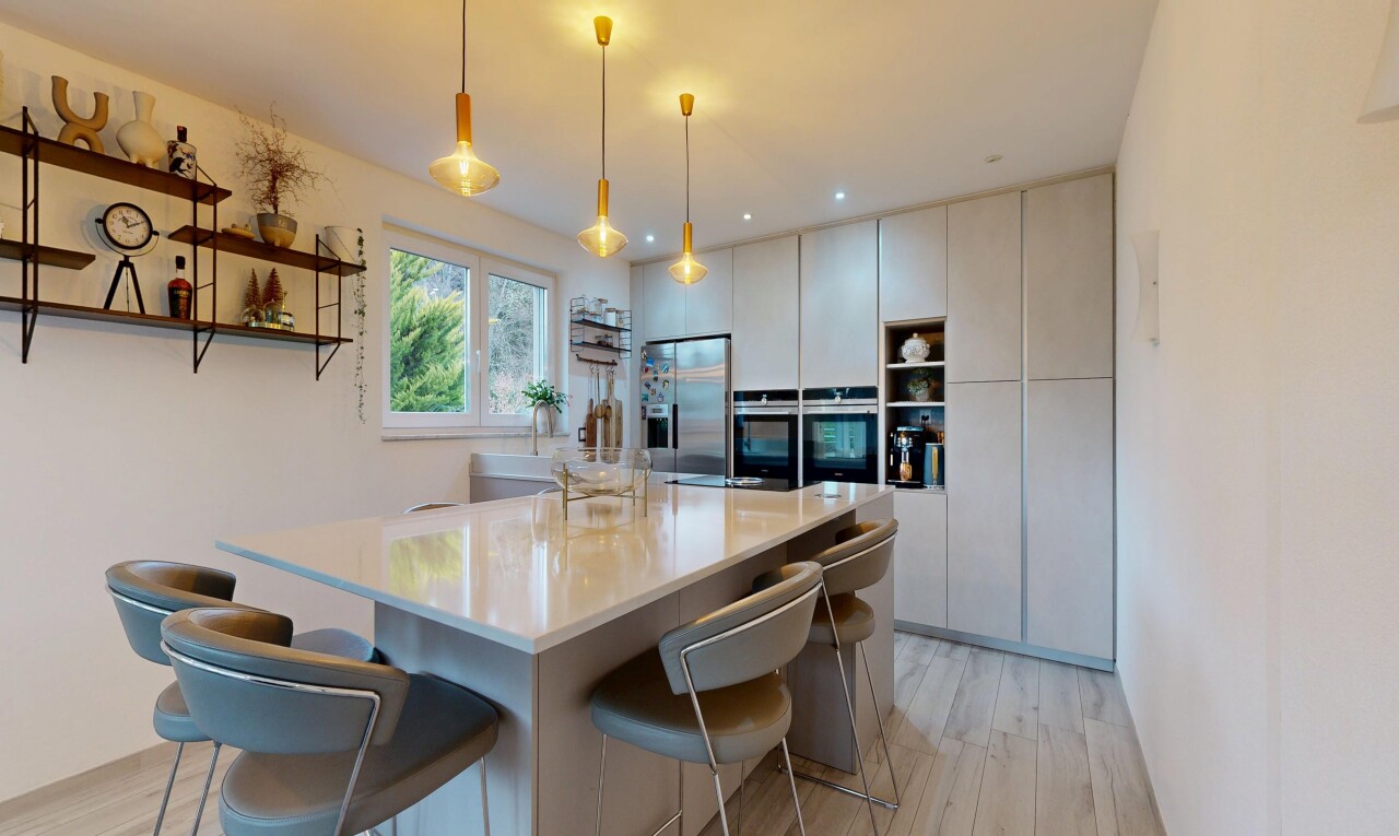 kitchen featuring open shelves, decorative light fixtures, a breakfast bar area, stainless steel appliances, and light wood-style floors