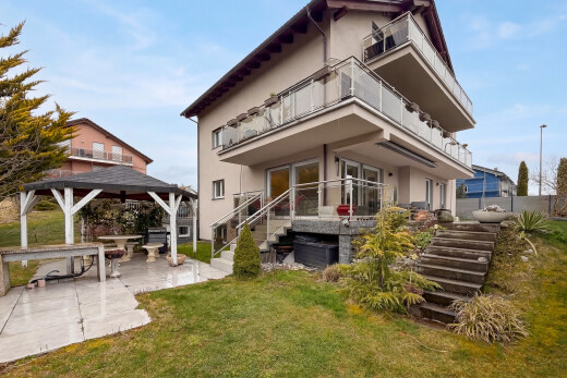 view of home featuring a balcony, a patio, stucco siding, a yard, and a gazebo