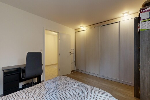 room with light wood-type flooring and a closet