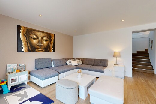 salon avec wood finish stairs, escaliers, drywall, cloison sèche, et wood finish floor
