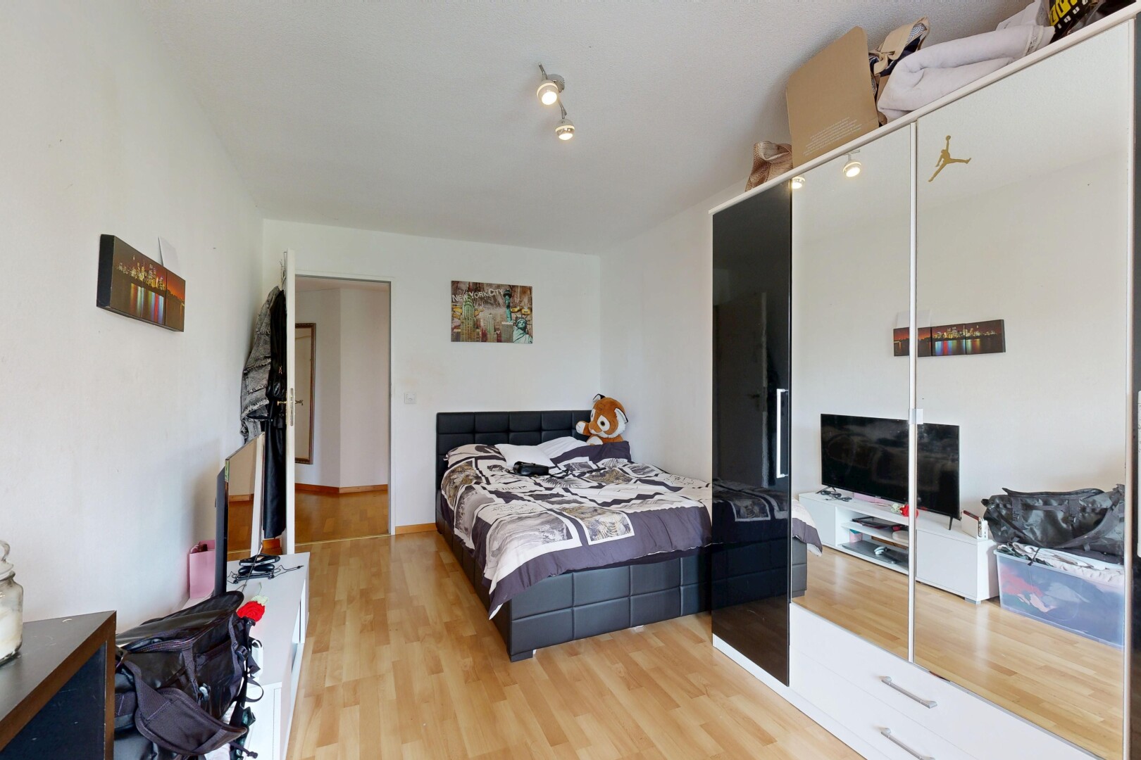 room with a closet and light wood finished floors