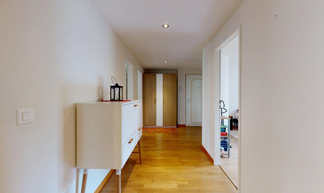hall with light wood-type flooring and recessed lighting