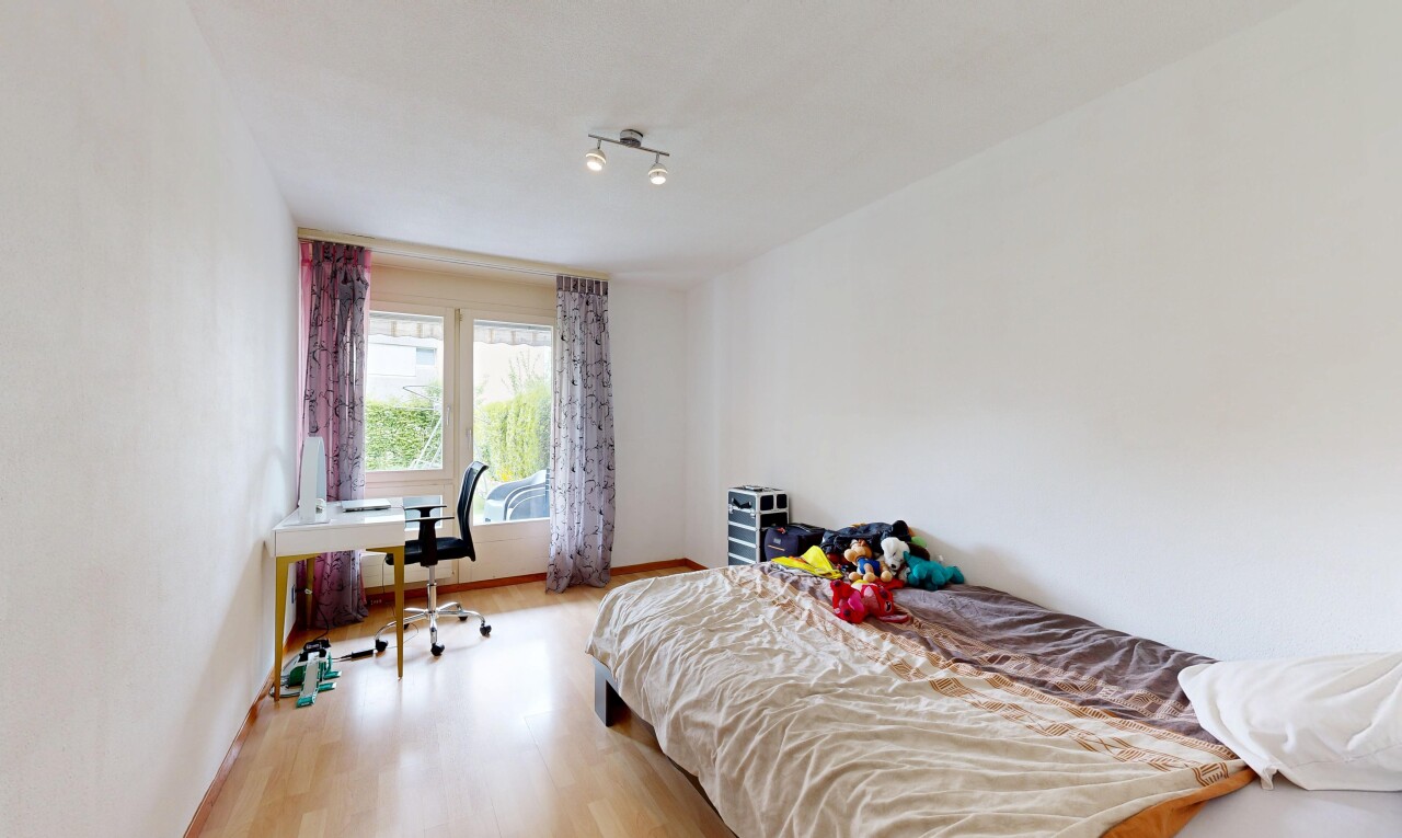 room / bedroom with light wood-type flooring and an office area