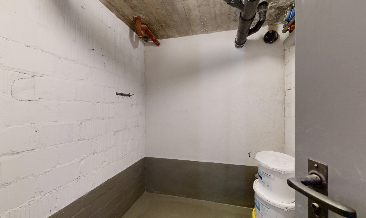 bathroom with concrete block wall and toilet