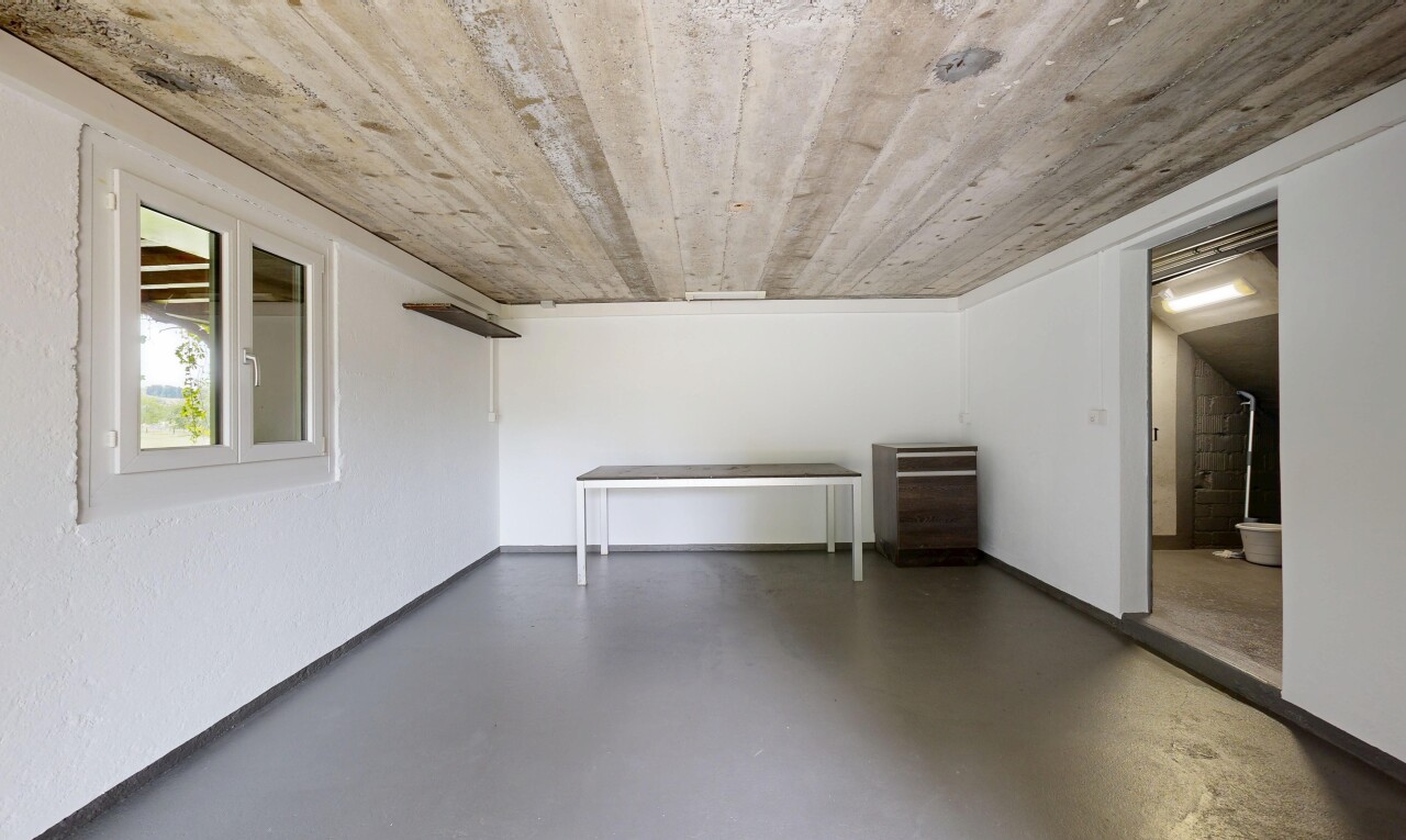 spare room with concrete flooring and baseboards