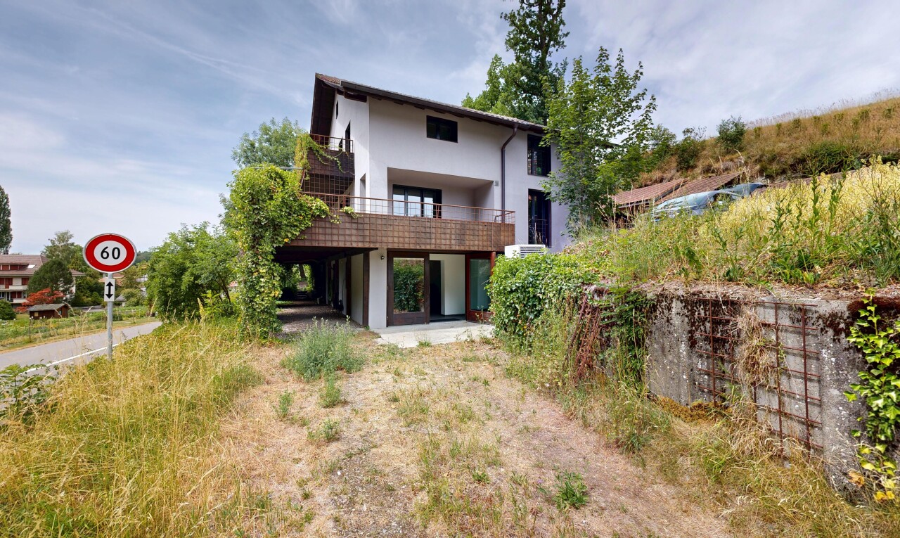 outdoor house featuring stucco siding, a patio area, and a balcony