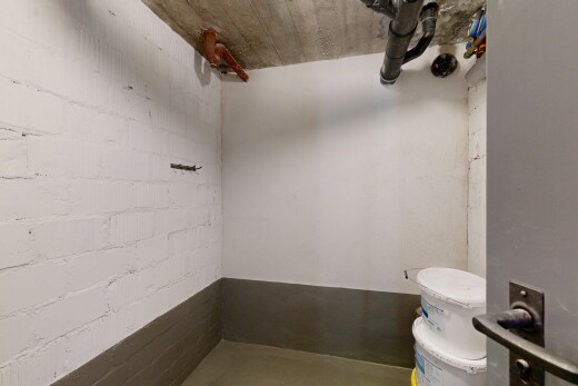 bathroom with concrete block wall and toilet