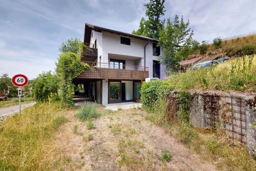 outdoor house featuring stucco siding, a patio area, and a balcony