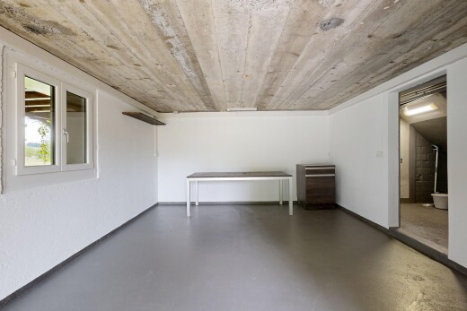 spare room with concrete flooring and baseboards