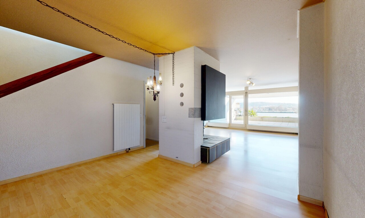 pièce vide avec lumière naturelle, natural light, radiateur, inside property, et sol en finition bois
