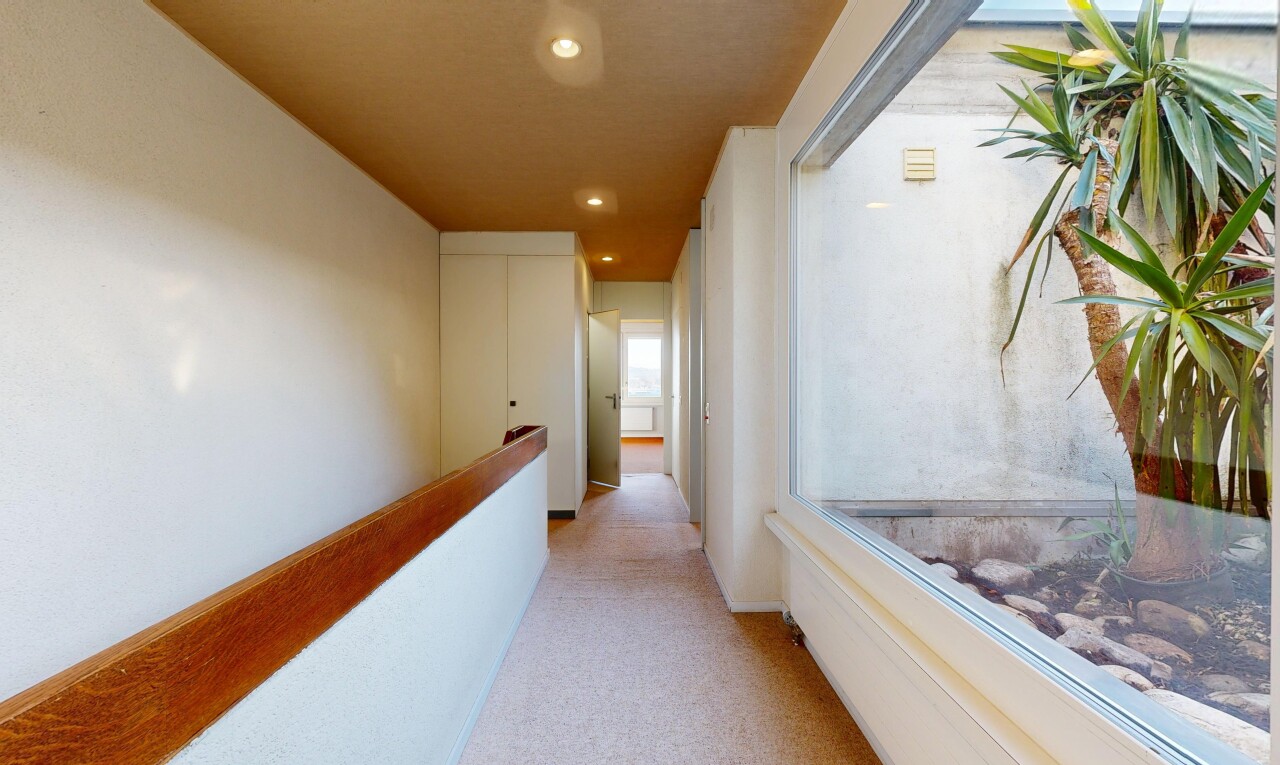 couloir avec moquette, carpet, cloison sèche, drywall, et éclairage encastré
