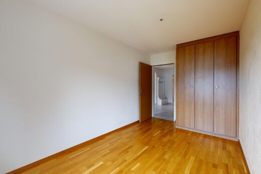 zimmer / schlafzimmer mit inside property, kleiderschrank, holzfußboden, wood finish floor, und gipskartonwand