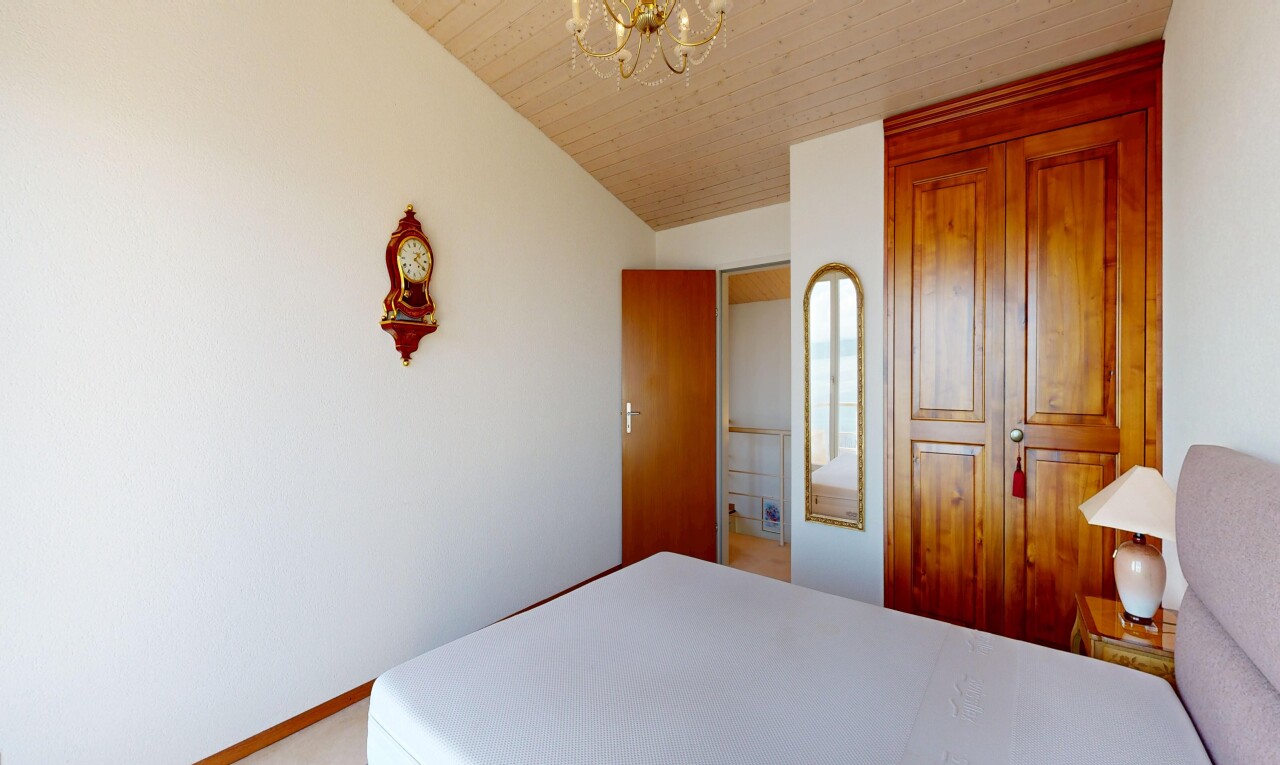 zimmer / schlafzimmer mit gipskartonwand, drywall, bemerkenswerter kronleuchter, inside property, und dachschräge