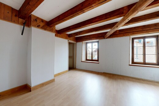 unfurnished room featuring beam ceiling and light wood-style floors