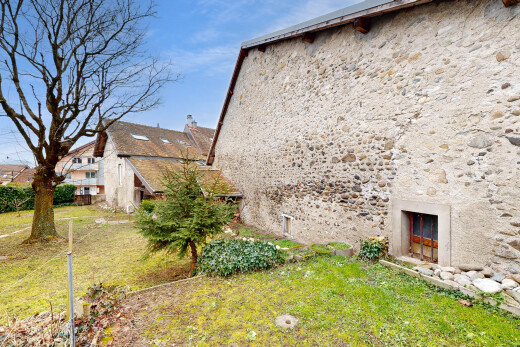 view of property with a yard and a chimney