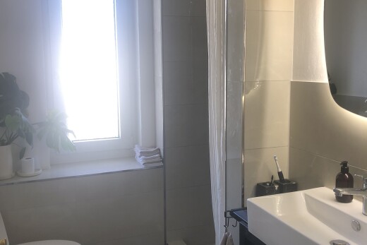 full bath with a sink and a shower stall