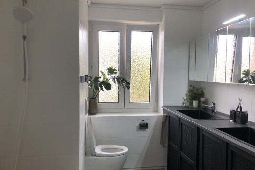 full bath featuring double vanity, ornamental molding, and a shower