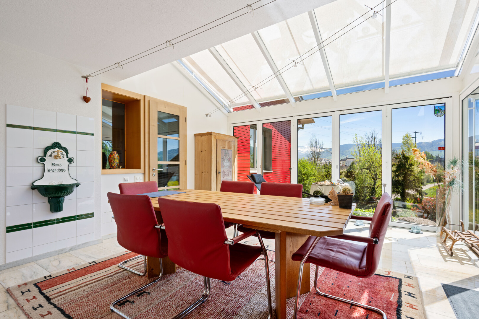 dining space with a skylight and a mountain view