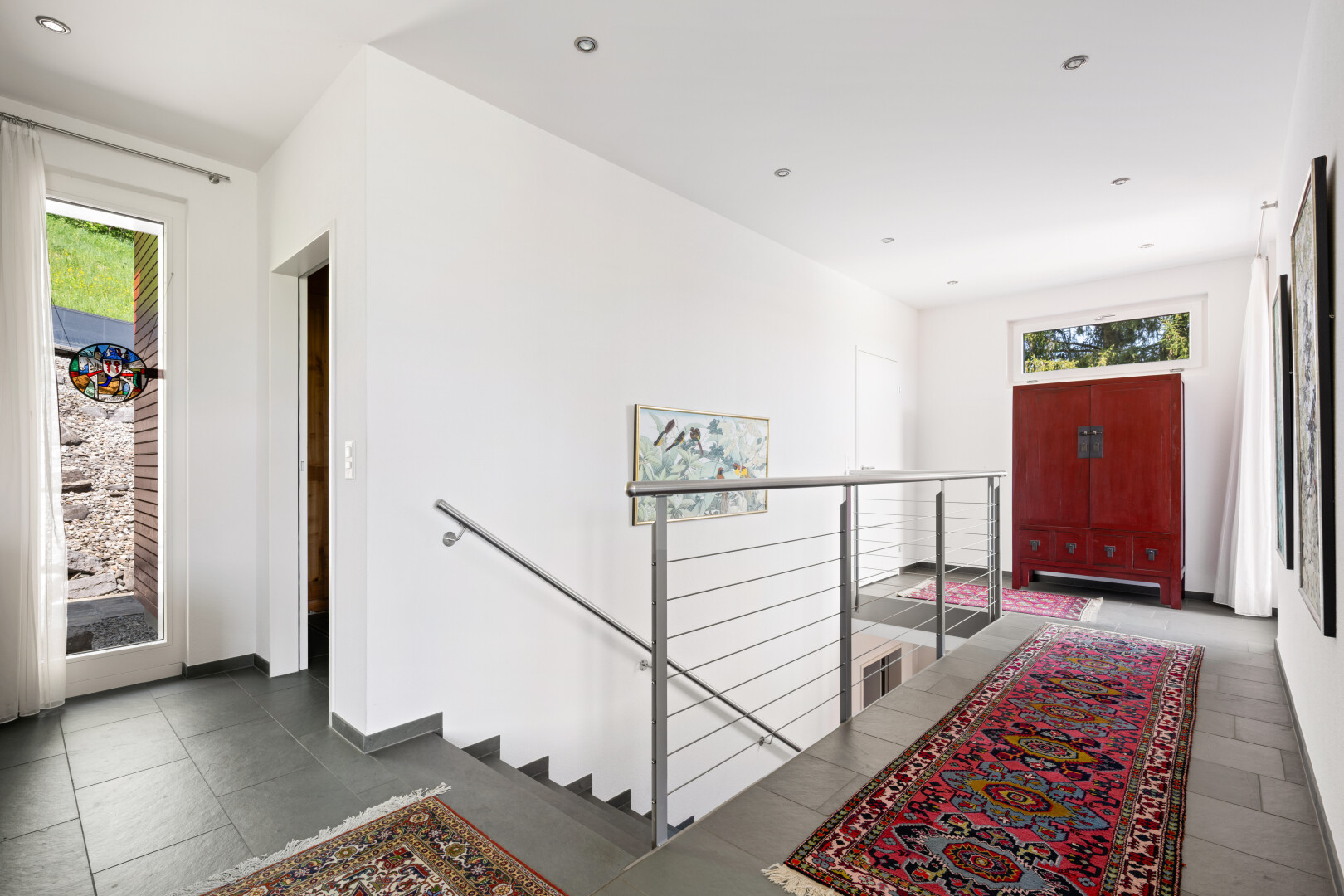 hallway featuring an upstairs landing and recessed lighting