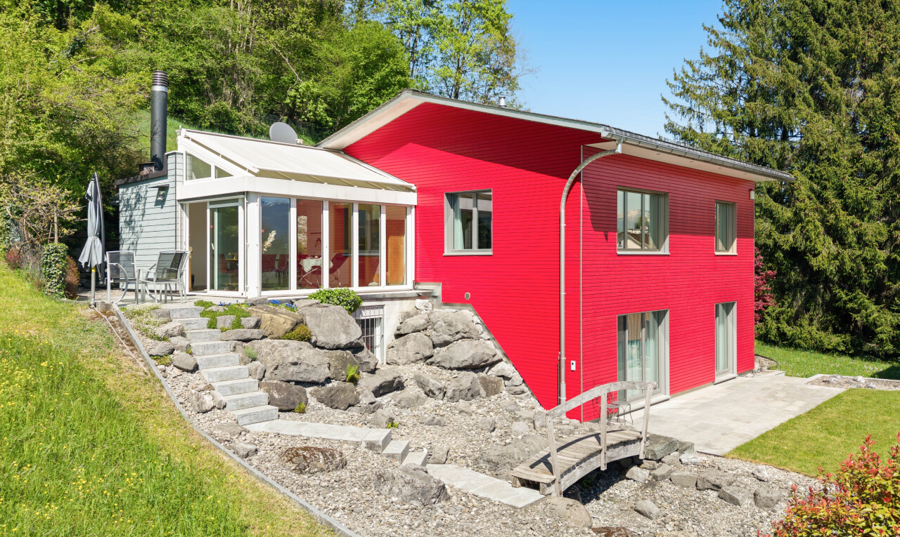 view of property featuring a yard, a patio, and a sunroom