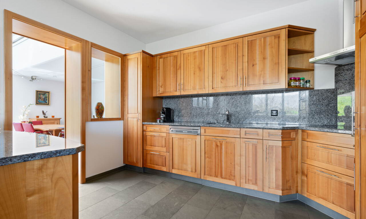 kitchen featuring open shelves, tasteful backsplash, dark stone countertops, dishwasher, and dark tile patterned flooring