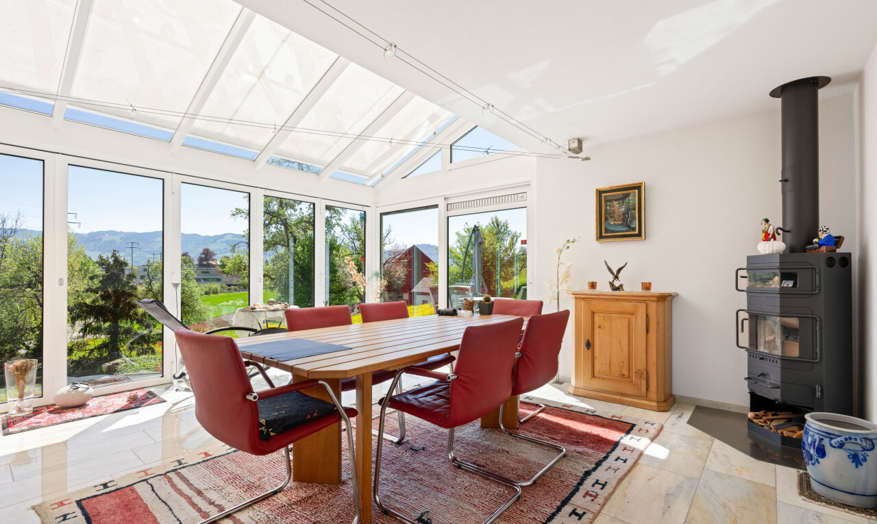 dining area with a mountain view and lofted ceiling
