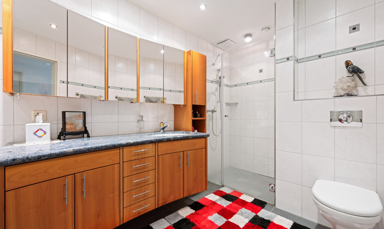 kitchen with tile walls, wood finish cabinetry, and recessed lighting