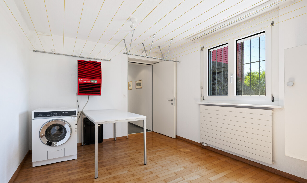 laundry room with washer / clothes dryer, radiator, and light wood-style floors