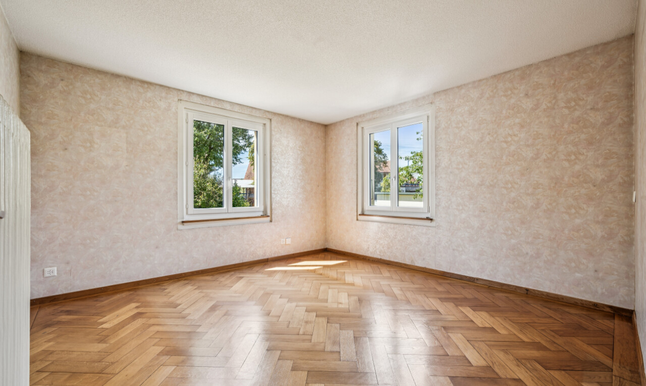spare room featuring parquet flooring and wallpapered walls