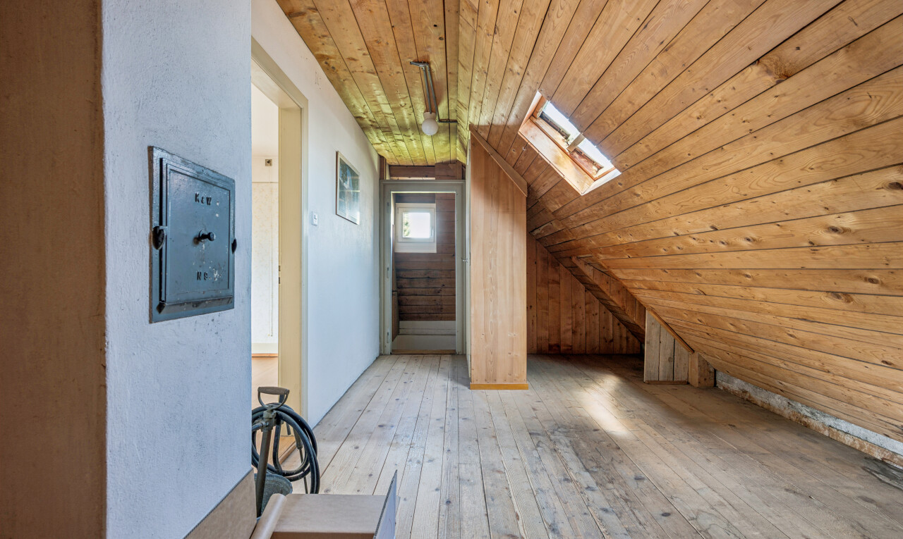 corridor with wood ceiling, hardwood / wood-style flooring, lofted ceiling with skylight, and wooden walls